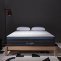 Helix Sunset mattress on a wooden bed frame with a dark wall background