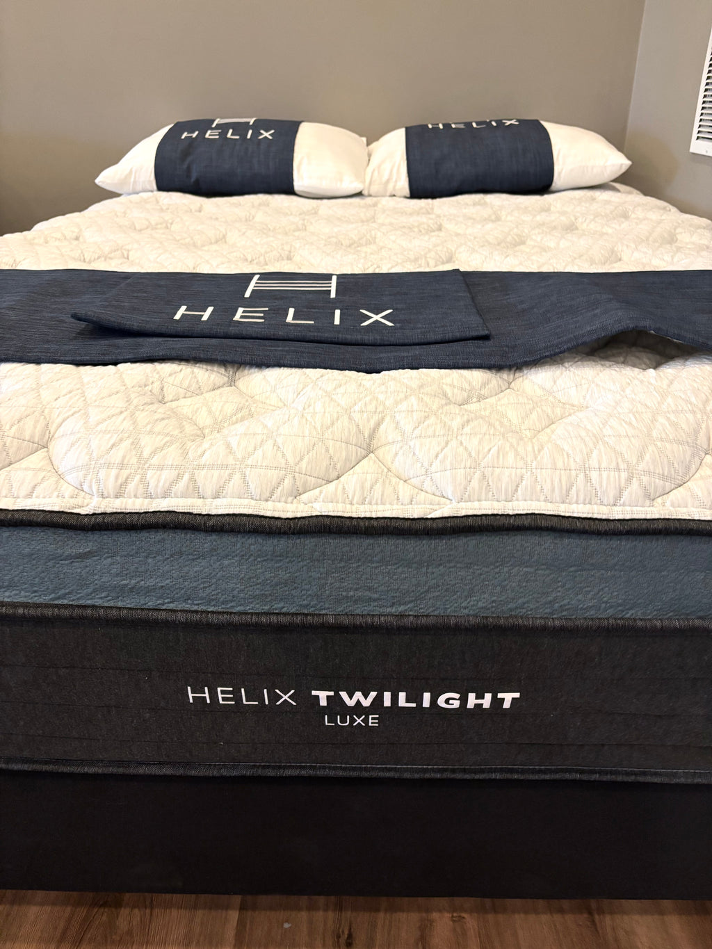 Helix Twilight Luxe mattress with branded bedding on a bed.