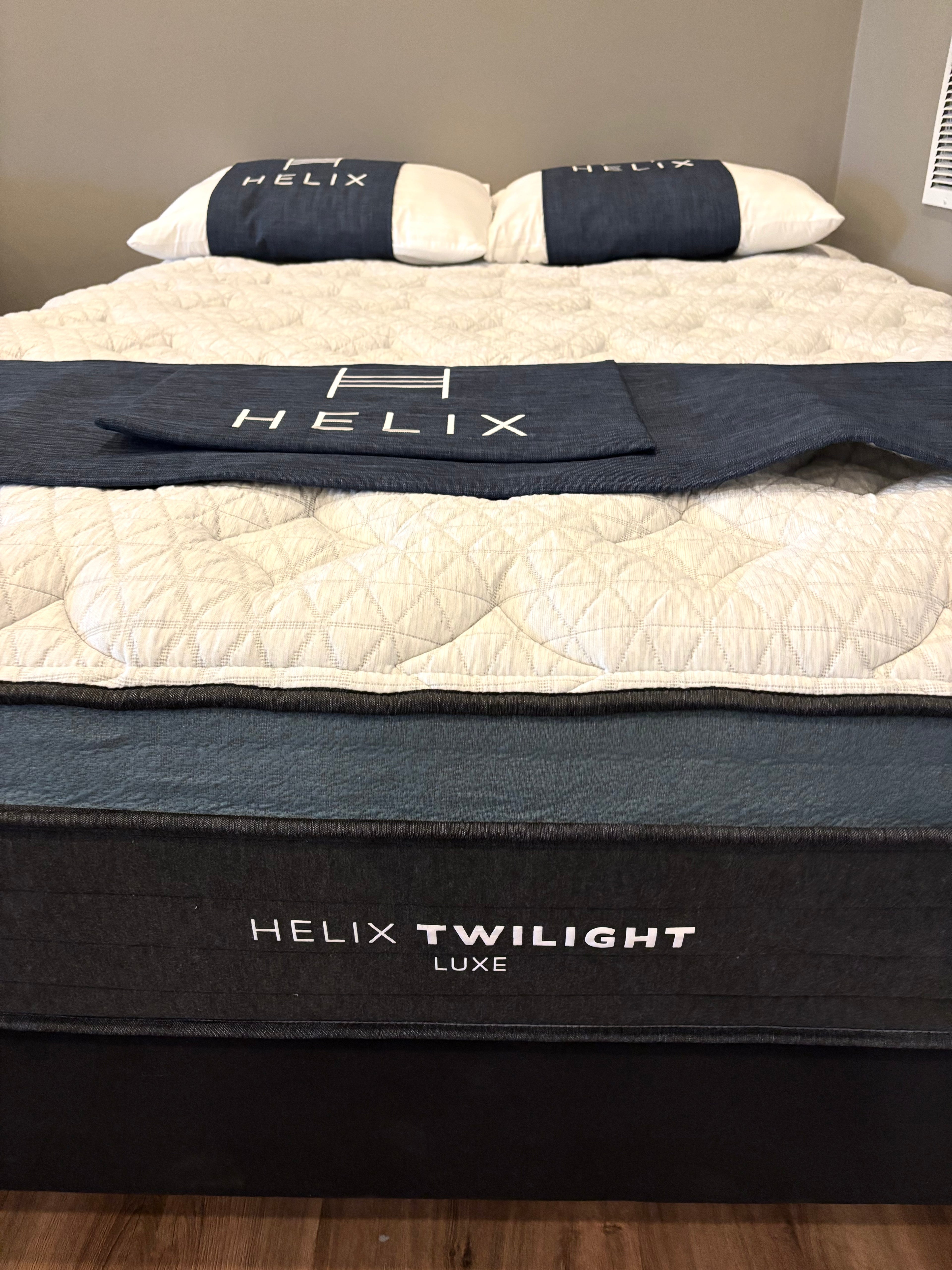 Helix Twilight Luxe mattress with branded bedding on a bed.